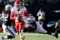 Kansas City Chiefs quarterback Patrick Mahomes (15) sheds tackle by Oakland Raiders defensive e ...