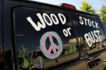 FILE - This Aug. 14, 2009 file photo shows a van decorated with "Woodstock or Bust" a ...