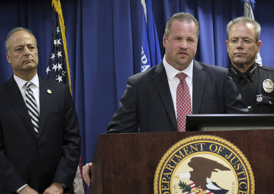 FBI Special Agent Ryan Young, center, is flanked by United States Attorney Nick Hanna, left, an ...