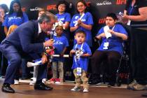 Bruce Buffer, the official announcer for UFC events, tells Jon Ryan Maguiat, 4, on Monday, Apri ...