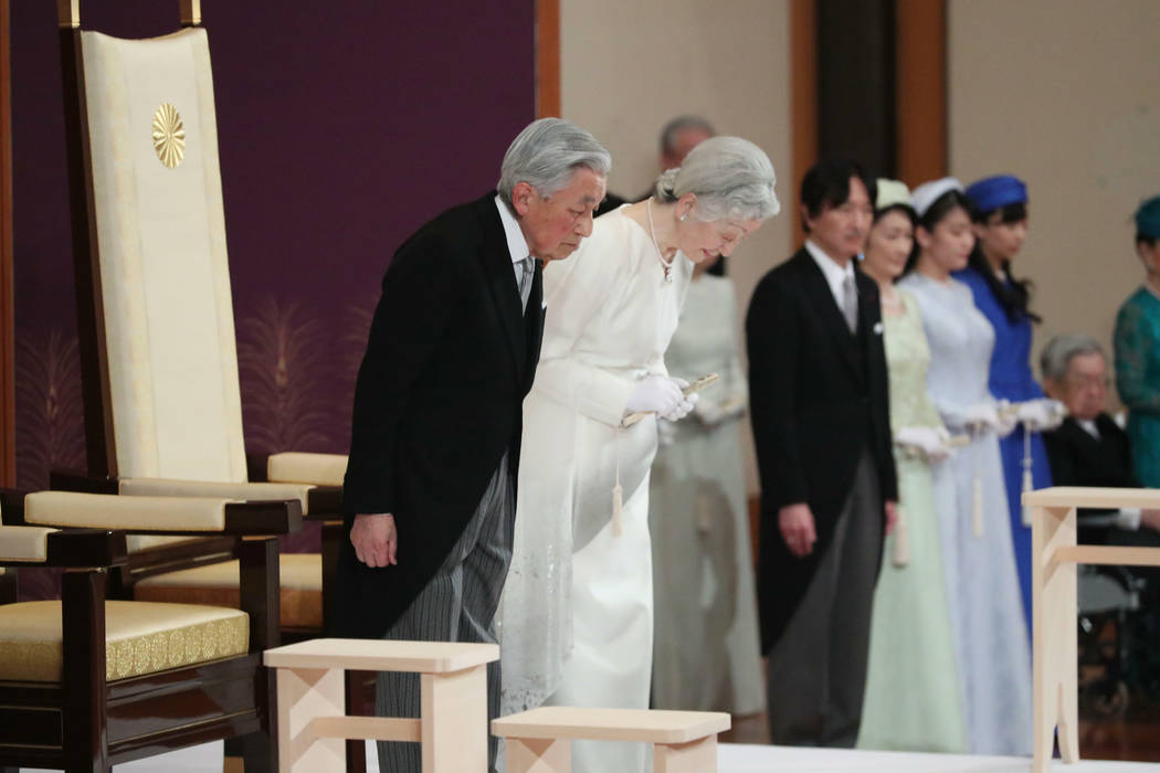 Japan's Emperor Akihito, left, and Empress Michiko, second left, bow as they prepare to leave a ...
