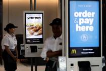 Employees stand Aug. 8, 2018, in McDonald's Chicago flagship restaurant. McDonald's Corp. repor ...