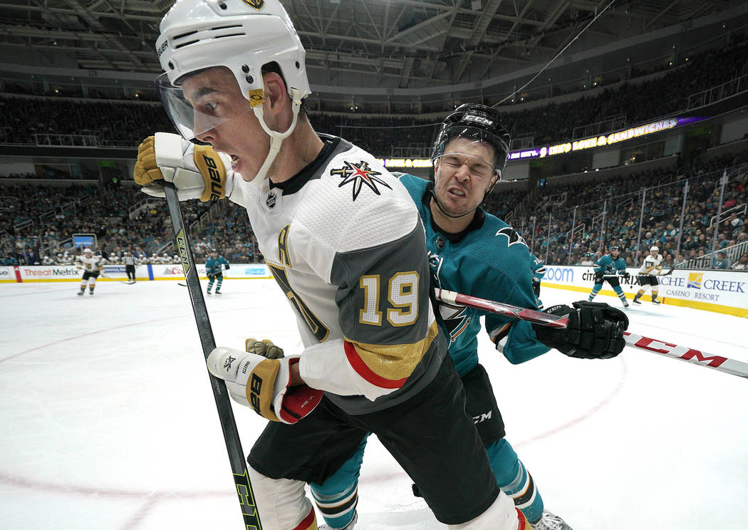 Vegas Golden Knights right wing Reilly Smith (19) is checked into the boards by San Jose Sharks ...