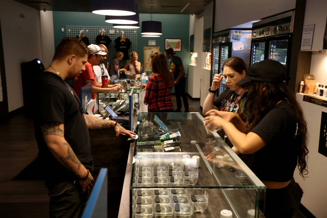 Eddie Medina of Seattle checks out product with Lindsay Steel, right, and Alyssa Jusino at Exha ...