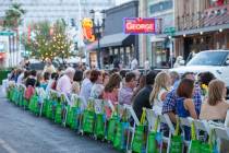 Guests sit family-style at a long table for Project Dinner Table at Downtown3rd in 2014. (Speci ...