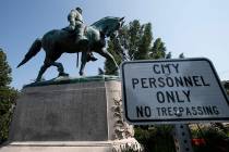 A No Trespassing sign is displayed in front of a statue of Robert E. Lee on Aug. 6, 2018, in Ch ...