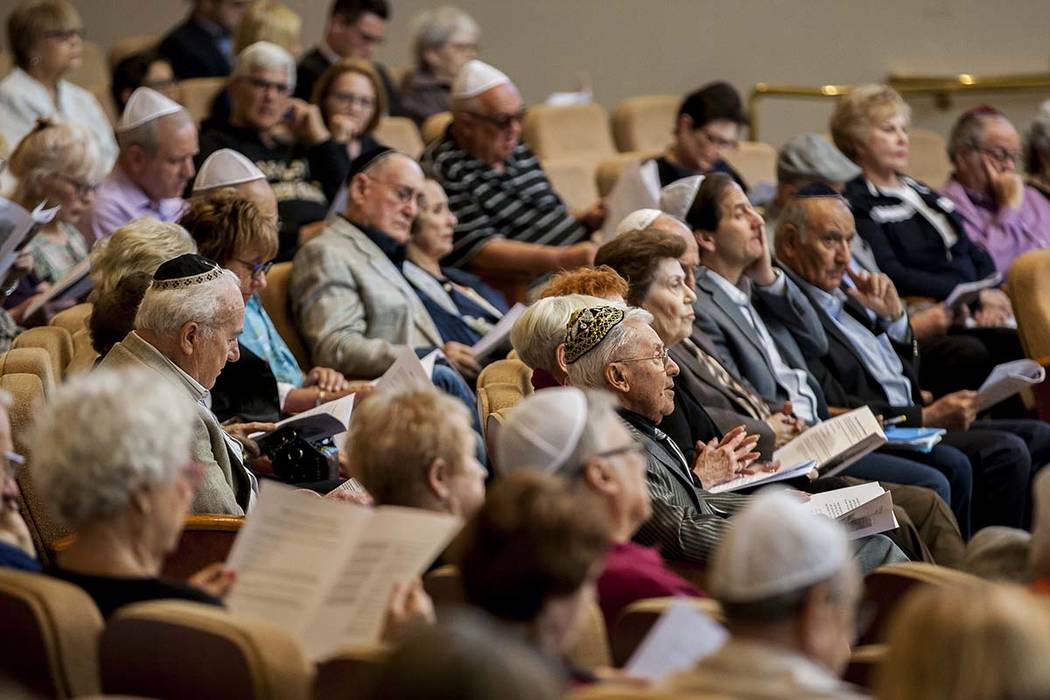 Jews come together to listen to readings, speakers and music during a Yom Hashoah service to re ...