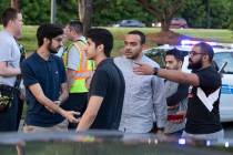 People gather across from the campus of University of North Carolina at Charlotte after a shoot ...