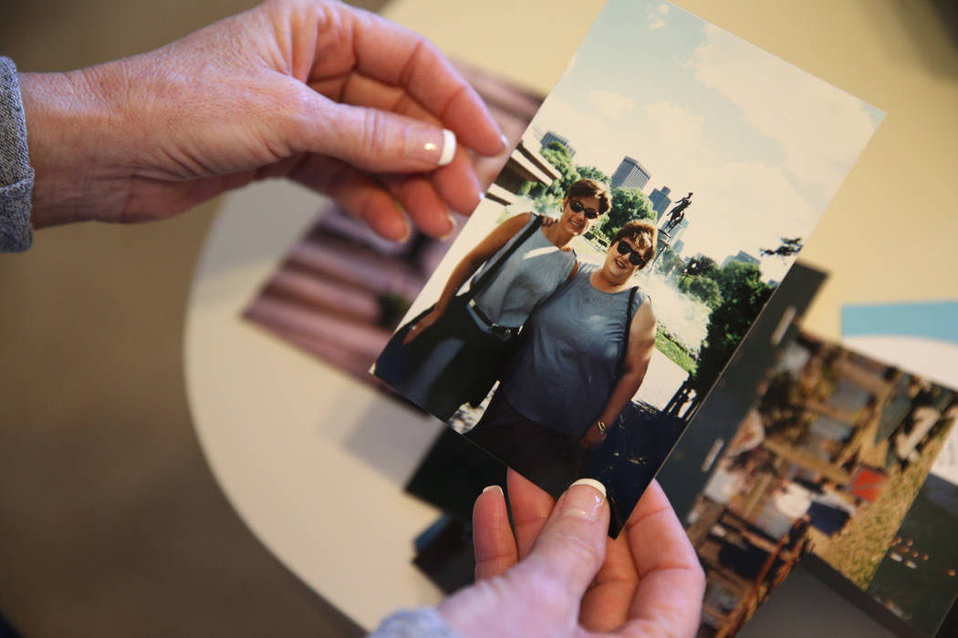 Bea Aikens shows a picture of herself with her sister Lanie, at her Boulder City home, Thursday ...