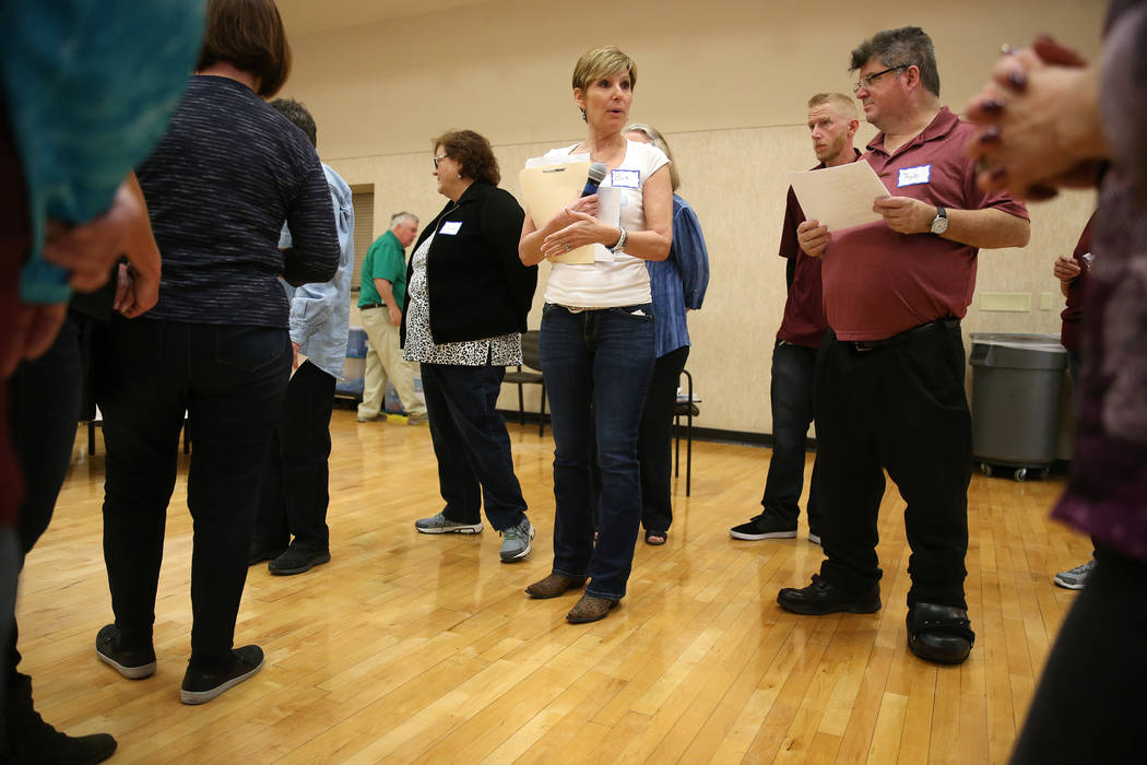 Bea Aikens, center, gives directions during a National Problem Gambling Awareness Month event a ...