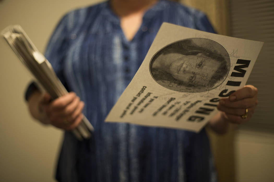 Rhonda Hunnel holds a missing person flyer for her daughter Regina Krieger at her home in Hende ...