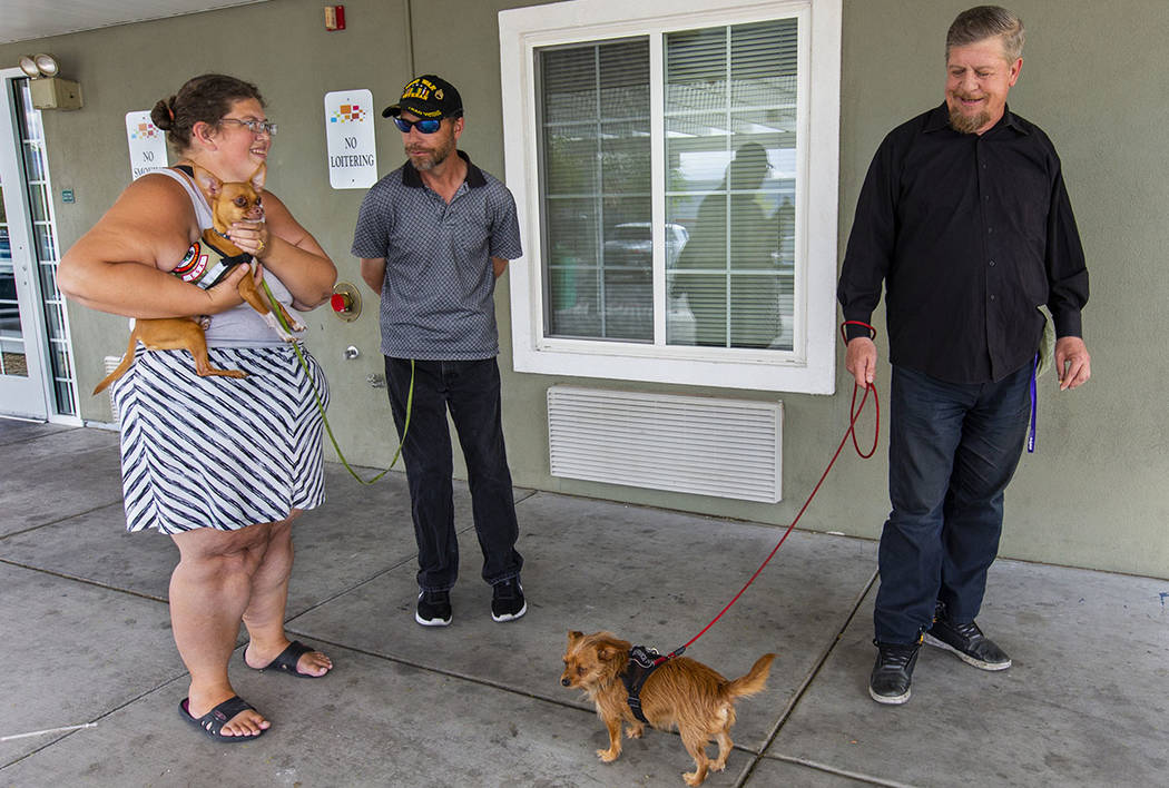 Ron Cochran, from right, with his dog Cookie, visits with friends Christian Bridges and Rebecca ...