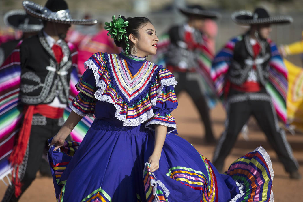 Mariajose Valdez, left, a dancer with Federación de Poblanos en Las Vegas performs during a C ...