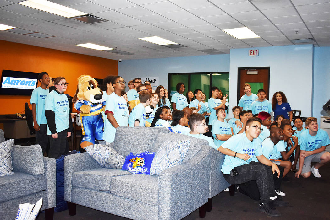 The group of teenagers pose for a photo in their new center donated by Aaron's. Rachel Spacek/L ...