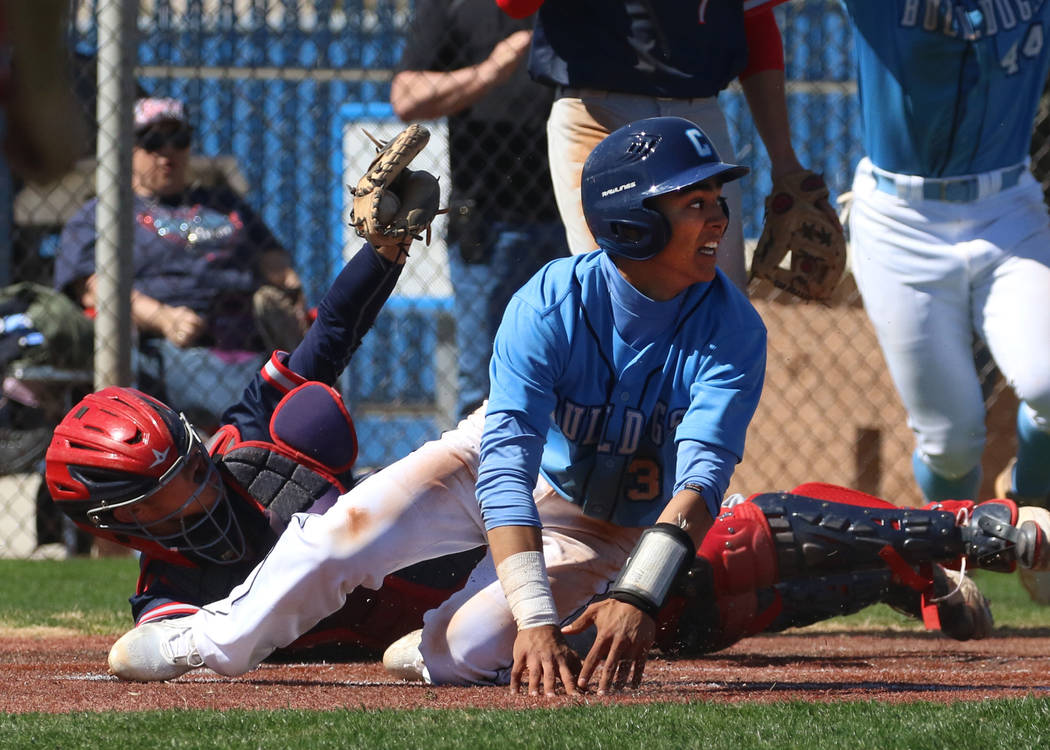 Centennial's Anthony Martinez, left, avoids a tag from Liberty's catcher James Katona as he sco ...