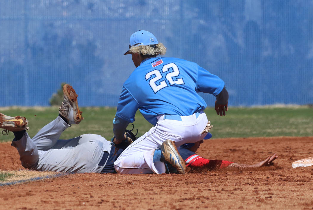 Centennial's shortstop Rene Almarez (22) tags Liberty's Chase Galleps at second during their ba ...