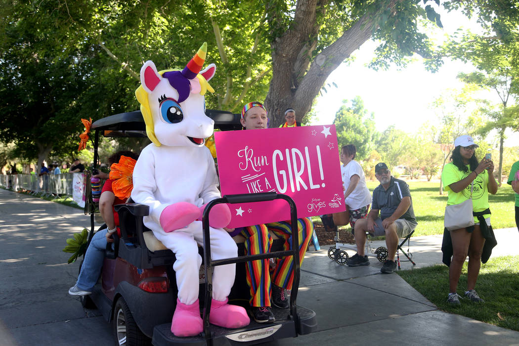 The Unicorn and Trace Klump wait at the beginning of the Girls on the Run Las Vegas 5K at UNLV ...