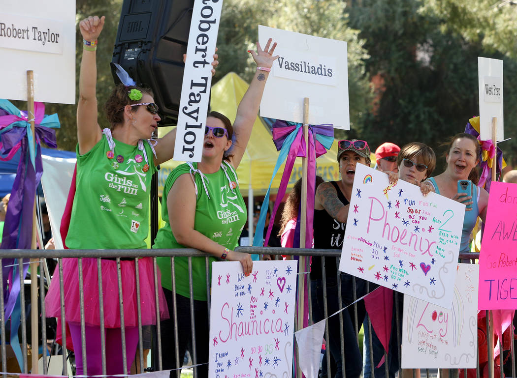 The crowd cheers for the runners at the Girls on the Run Las Vegas 5K at UNLV in Las Vegas, Sun ...
