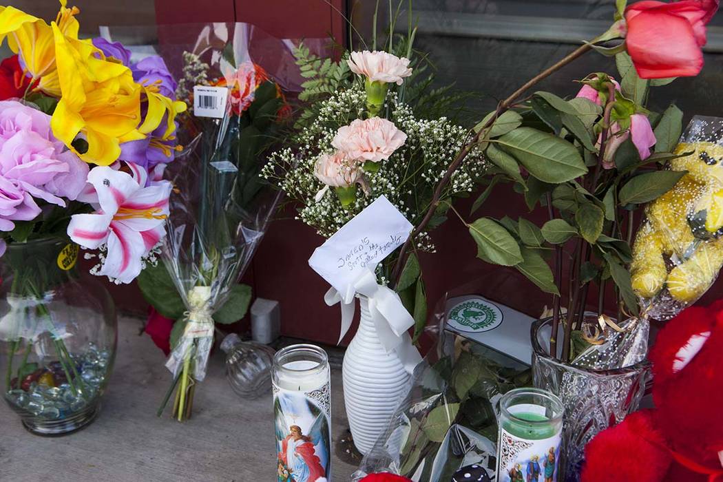 Flowers sit in front of Jared, a jewelry store where employee Kimberlee Ann Kincaid-Hill died a ...