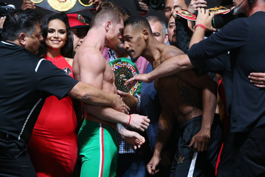 Saul "Canelo" Alvarez, left, and Daniel Jacobs, face off during their weigh-in at T-M ...