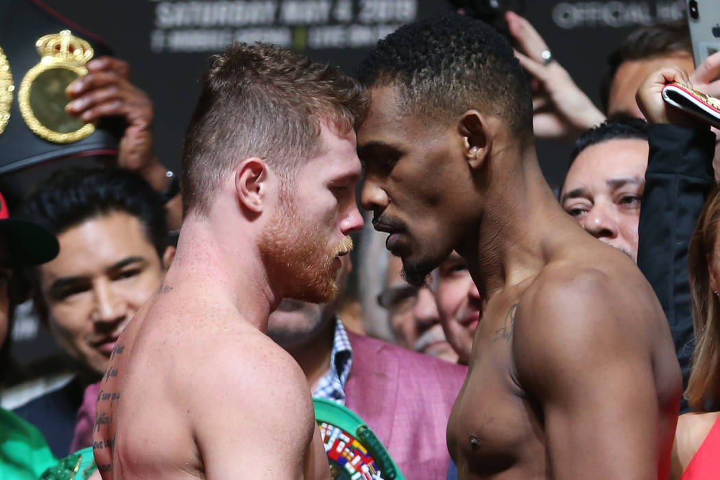 Saul "Canelo" Alvarez and Daniel Jacobs face off during their weigh-in at T-Mobile Ar ...