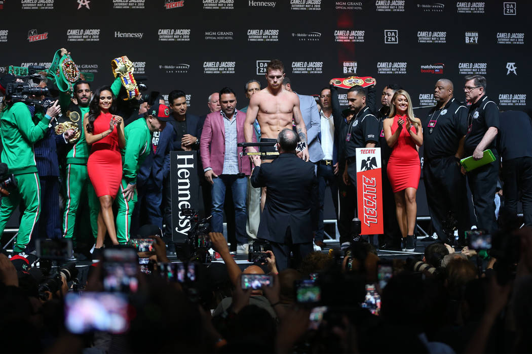 Saul "Canelo" Alvarez stands on the scale for his weigh-in at T-Mobile Arena in Las V ...