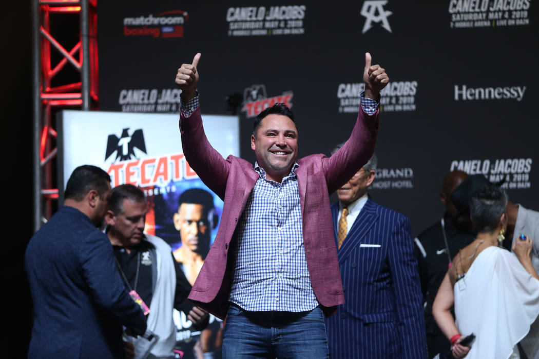 Boxing promoter Oscar De La Hoya reacts to fans during a weigh-in for Saul "Canelo" A ...