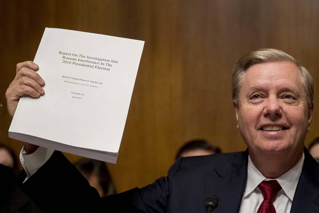 Chairman Sen. Lindsey Graham, R-S.C., holds up a copy of the Mueller Report during a Senate Jud ...