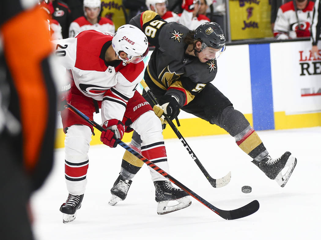 Golden Knights center Erik Haula (56) gets control of the puck over Carolina Hurricanes center ...
