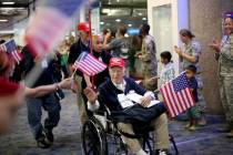 U.S. Air Force veteran Frank Carmean, 94, greets people as they welcome him back from a trip to ...