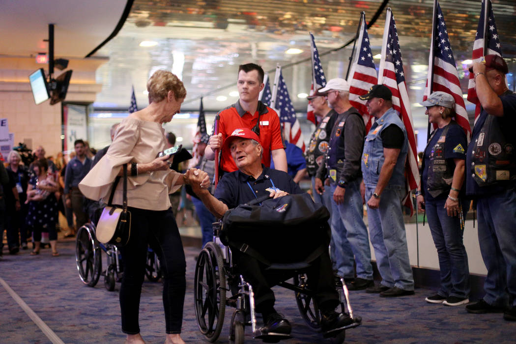 Gayle Albright greets her husband, veteran Gene Albright, upon his return from a trip to visit ...