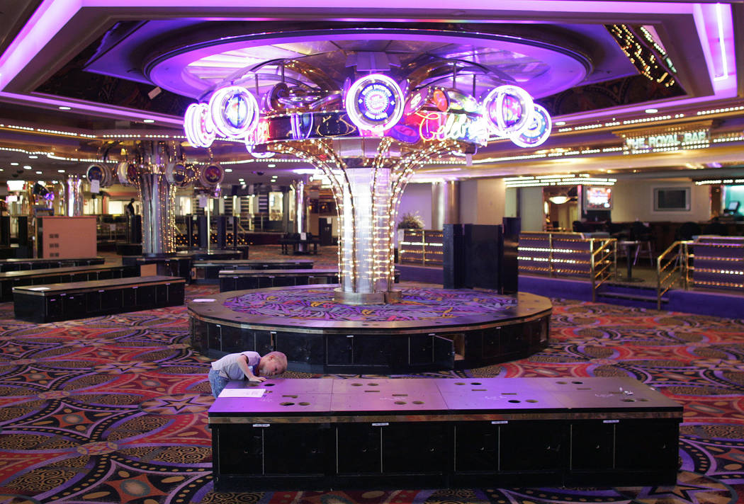Five-year-old Logan Sander searches for lost change where slot machines used to be at the Stard ...