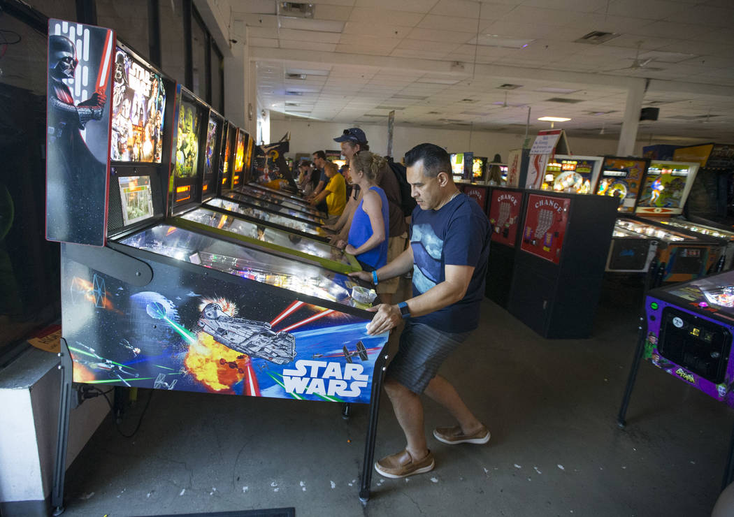 Joel Pastrana of Los Angeles, Calif., plays on a Star Wars pinball machine during a visit to th ...