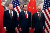 Chinese Vice Premier Liu He, right, poses with U.S. Treasury Secretary Steven Mnuchin, center, ...