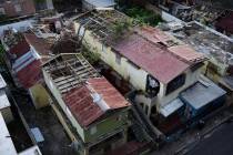 FILE - In this Nov. 15, 2017 file photo, buildings with their roofs damaged by the winds of Hur ...