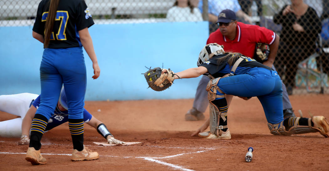 Basic's Jordan Stinett (10) slides across home plate as Sierra Vista catcher Aaliyah Medina (1 ...