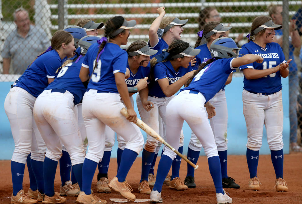 Basic players celebrate a home run by Sierra McClean (12) in the fourth inning of their Desert ...