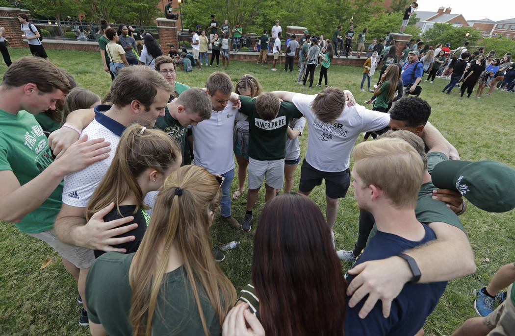 Students pray together during a vigil at the University of North Carolina-Charlotte in Charlott ...