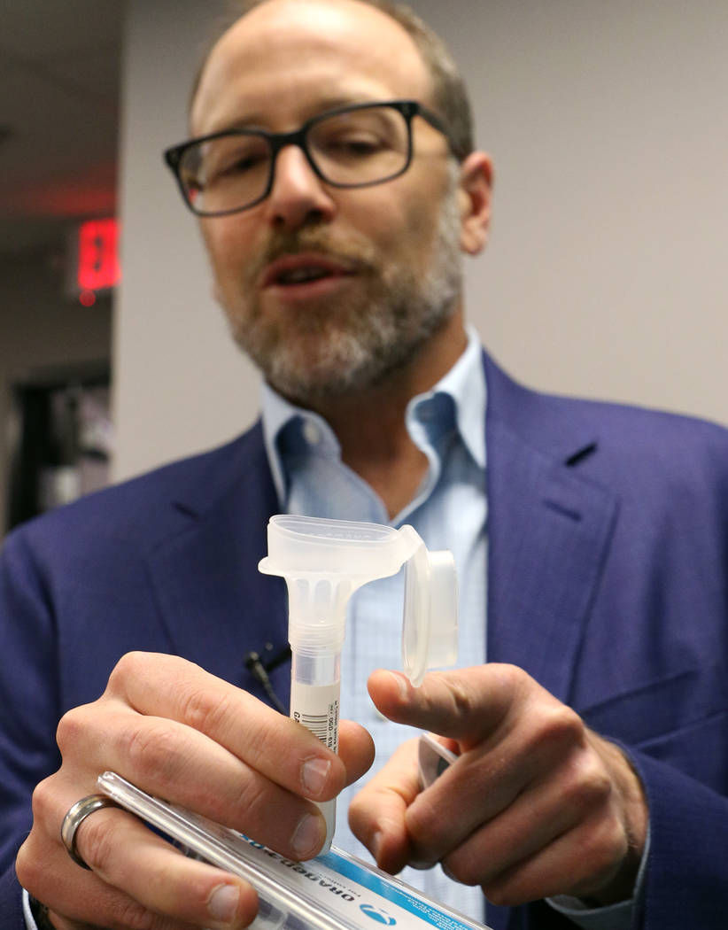 Dr. Joe Grzymski, principal investigator of the Healthy Nevada Project, holds DNA Genotek's sal ...