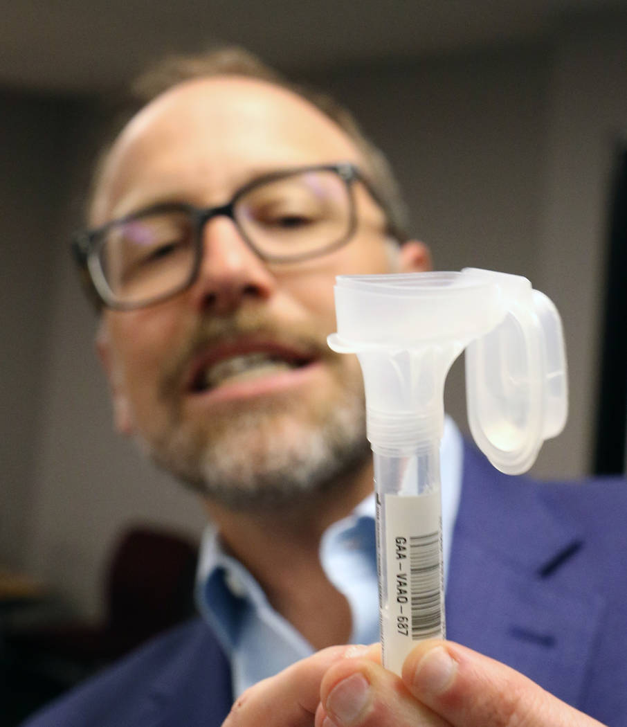Dr. Joe Grzymski, principal investigator of the Healthy Nevada Project, holds DNA Genotek's sal ...
