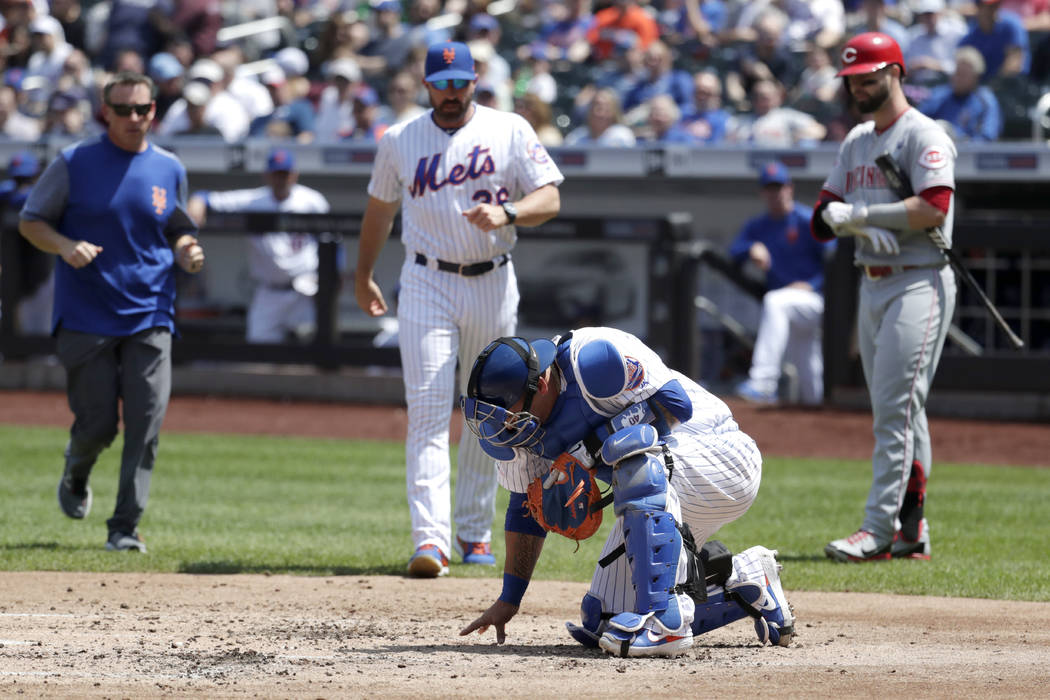New York Mets catcher Wilson Ramos reacts after taking a foul ball to the knee from Cincinnati ...