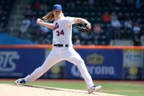 New York Mets starting pitcher Noah Syndergaard throws a pitch to Cincinnati Reds' Derek Dietri ...