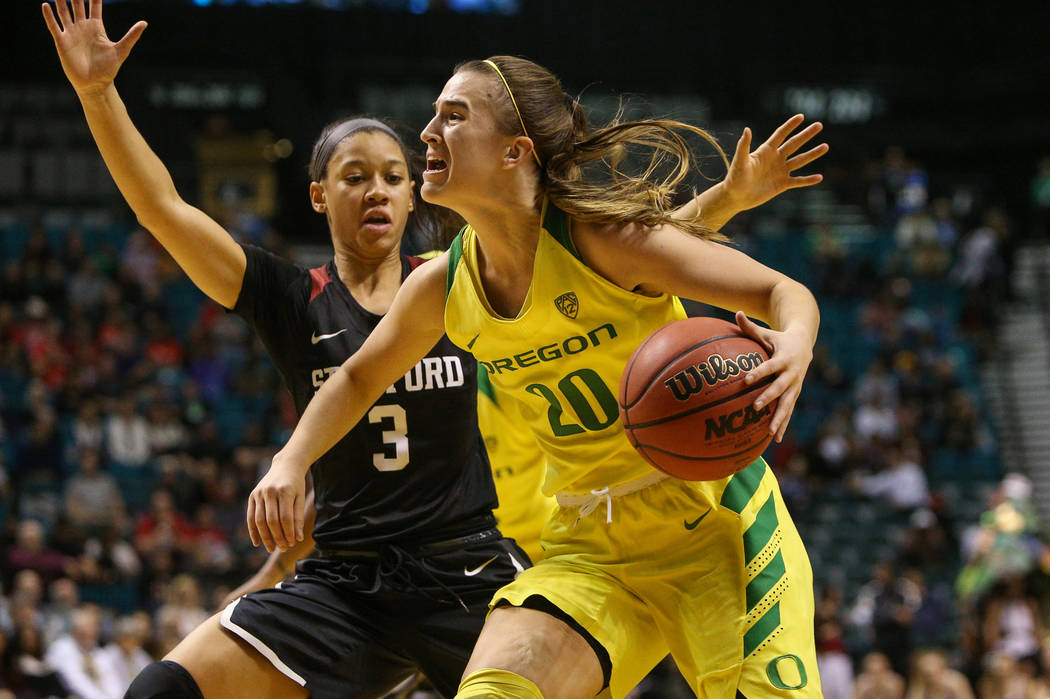 Oregon Ducks guard Sabrina Ionescu (20) looks to pass the ball while being guarded by Stanford ...