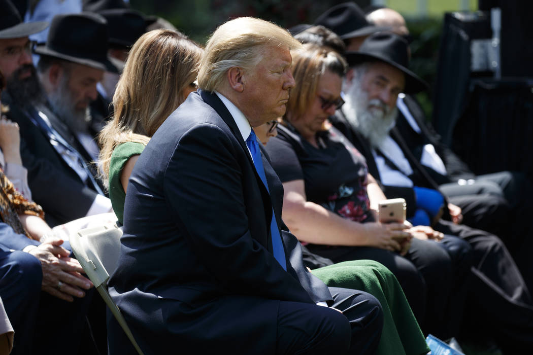 President Donald Trump prays during a National Day of Prayer event in the Rose Garden of the Wh ...