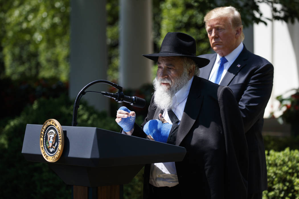 President Donald Trump looks on as Rabbi Yisroel Goldstein, survivor of the Poway, Calif synago ...