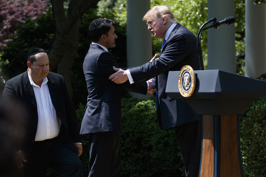 Jonathan Morales, left, and Oscar Stewart, center, are greeted by President Donald Trump during ...