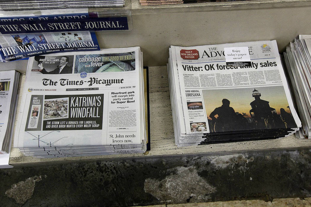 Free introductory copies of the Baton Rouge Advocate's new New Orleans edition, right, are seen ...