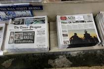 Free introductory copies of the Baton Rouge Advocate's new New Orleans edition, right, are seen ...