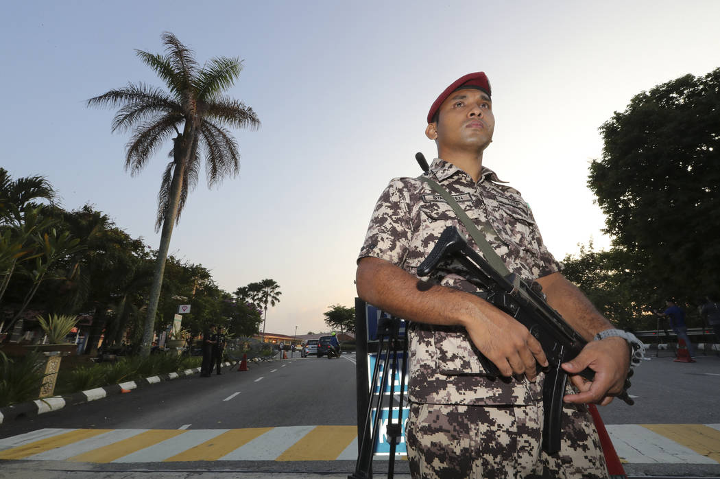 Prison security guards at the entrance of Kajang Women's Prison in Kajang, Malaysia, Friday, Ma ...