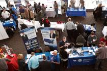 Visitors to a Pittsburgh veterans job fair meet March 7, 2019, with recruiters at Heinz Field i ...